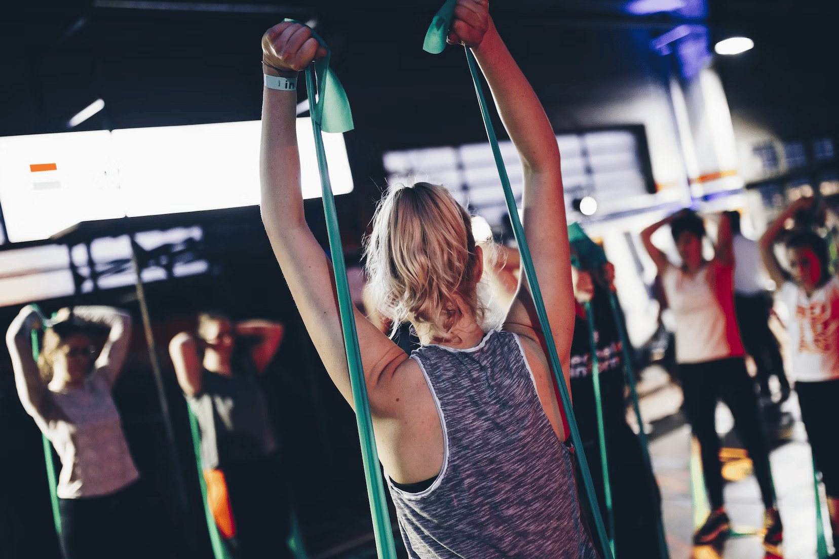 woman using resistance bands in a gym